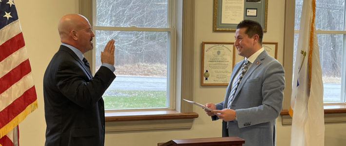 Chief Bennett being sworn in by his Town Administrator Adam Lamontagne.